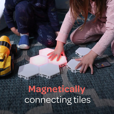 Children playing with 7 Piece Tap Tap Sensory Lights Kit With Touch And Remote Control Multicolor Magnetic Hexagon Tiles on floor.