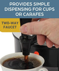 Hand using the two-way faucet of the 42-Cup Coffee Urn With Automatic Temperature Control to pour coffee into a cup.
