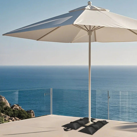 Heavy Duty Umbrella Base Weights Set Of 4 Fillable Water Bags For Patio Garden And Backyard Black Four Pack Easy To Fill With Water No Sand Required No Mess Or Fuss Portable When Empty Holds Down Any Patio Umbrella Stand on a patio overlooking the sea.