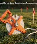 Pro Grade Fiberglass Tape Measure Half Inch By One Hundred Foot Open Reel Dual Sided For Inches And Feet With Ergonomic Grip Water Resistant Rugged Orange Tool For Builders And Pros on grass with measurement stakes