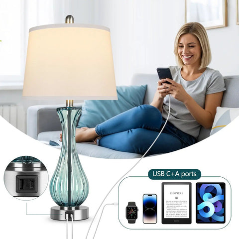 Woman smiling while using phone with Coastal Glass Table Lamp Set Of 2, 27.5 Inch Blue Nautical Bedside Lamps visible, USB ports shown.