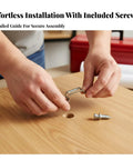 Hands installing a heavy duty invisible furniture connector for cabinet assembly with screws on a wooden surface.