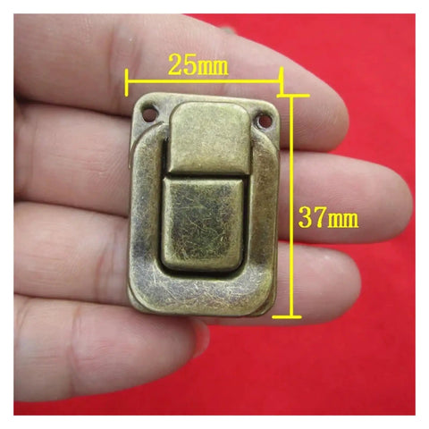 Close-up of hand holding one latch from Sturdy Iron Box Hasps Set Of 10 Latches With Antique Bronze Finish And Gold Tone, 25x37mm size.