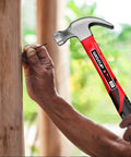 Person using an 8 oz hammer from Ultra Handy 560 Piece Nails And Hammer Set With 10ft Tape Measure for Picture Hanging and DIY Projects