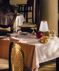 Cordless Table Lamp With Rechargeable Battery in a restaurant setting, featuring LED touch lamp with crystal gold metal design.