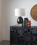 Stoneware Table Lamp In Black And White For Nightstands And Desks in cozy living room setting on carved cabinet