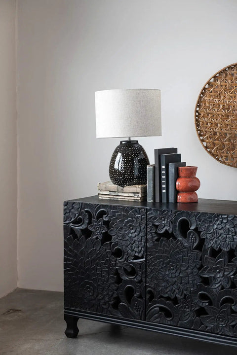 Stoneware Table Lamp In Black And White For Nightstands And Desks in cozy living room setting on carved cabinet