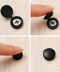 Close-up of Zero Hassle 100 Piece Hinged Screw Cover Set in durable black plastic for medium fasteners.