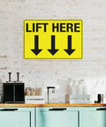 Wall-mounted yellow 8 By 12 Inch Equipment Guidance Sign Built Tough From Rust Resistant Aluminum with 'Lift Here' instruction and arrows.