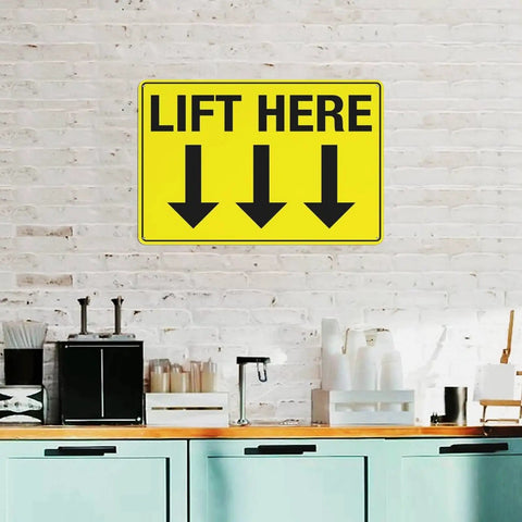 Wall-mounted yellow 8 By 12 Inch Equipment Guidance Sign Built Tough From Rust Resistant Aluminum with 'Lift Here' instruction and arrows.
