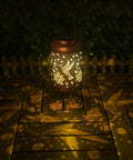 Hummingbird Solar Lanterns For Outdoor Garden Decor illuminating a wooden patio with gold copper finish, retro hummingbird design.