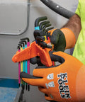 Person holding color coded hex key wrench set with long arm L style and ball end SAE and metric 18 piece kit in workshop.