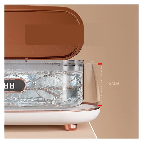 Slick Mini Ultrasonic Cleaner Doing Heavy Lifting For Jewelry And Eyewear Washing Machine with visible cleaning chamber.