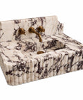 Calacatta Viola Marble Sink with Sculpted Backsplash, Fluted Vanity Washbasin, Hand-Carved Natural Stone Bathroom Basin, Custom Luxury Powder Room Sink at an angle showcasing the intricate veining.