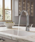 Pfister Vaneri Kitchen Faucet with Pull Down Sprayer, Polished Chrome, showcasing a high arc spout with water flowing in a bright kitchen.