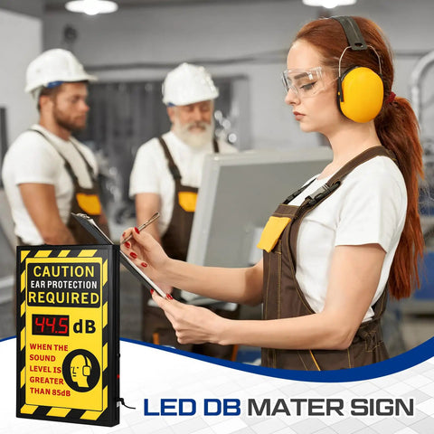 12 By 20 Inch Real Time Decibel Meter Sign With OSHA Caution Ear Protection Required, Wall Mount Aluminum Db Meter, Digital Display Of Current Noise Levels For Quick Safety Notice And Clear Workplace Communication. Worker in factory with LED dB sign