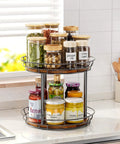 10 Inch Lazy Susan Turntable Organizer 2 Tier Round Rotating Spice Rack with glass jars on a kitchen countertop