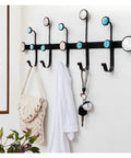 Heavy-Duty Wrought Iron Shell Wall Hooks, Double Robe And Coat Rack For Closets Bathrooms And Entryways, game-saving space organizer in use, holding bags and coat.