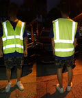 Person wearing Top Shelf High Visibility Reflective Safety Vest, Fluorescent Neon Yellow, heavy duty construction work gear.