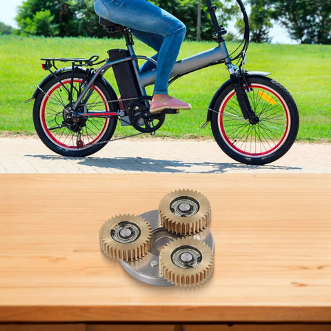 36T Copper Gear Set For Electric Bike Hub Motor Planetary System With Bearing And Copper Clutch Gear For E Bike Conversion Kit 38x38x12mm Built To Last Ride on a table with a bicycle in background.