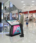 Top Shelf 49 Inch Interactive Touchscreen Kiosk With Smooth Ten Point Capacitive Panel And Rock Solid Android 11 Engine in a shopping mall.