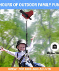 Child enjoying backyard zip line kit 120ft for kids and teens up to 330 lbs with stainless steel cable, harness, and helmet included