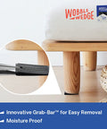 Rigid Black Plastic Shim Wedges fixing wobbly bed leg; interlocking ridges shown; 30 pack for DIY home improvement and furniture leveling.