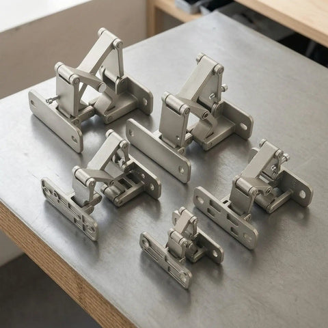 Straight Up Heavy Duty Conceal Hinge For Stone Doors And Fire Cabinets on a gray table, showcasing multiple sizes and angles.
