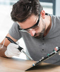 Person using soldering iron with 4 Piece 510 Thread Magnetic Adapter Kit Universal Threaded Screw Converter on circuit board.