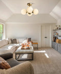 Antique Brass 4 Light Ceiling Light With Frosted Glass Globes, Mid Century Modern Chandelier in living room setting
