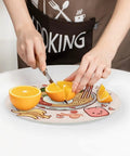 Person cutting oranges on Tempered Glass Cutting Board Counter Protector For Kitchen Home Office And Travel Portable Non Slip Cutting Surface That Resists Knife Marks Easy Clean Up And Keeps Your Prep Space Sleek And Clean