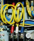 Installed Dual Row 3 Position Wire Barrier Block Terminal Strip 600V 100A with clear cover and wires in electrical panel