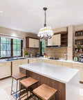 Modern kitchen with island and stools under pendant light, showcasing 4 Inch Gimbal LED Recessed Lights Kit Six Pack With Junction Box