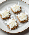 Clear Self Sealing Cellophane Bags 4x6 Inches 200 Pcs Resealable Bags For Cookies Candy And Treats Packaging Transparent Bakery Grade Bags With Easy Tear Grips For Quick Pack, displaying four cookies on a plate.