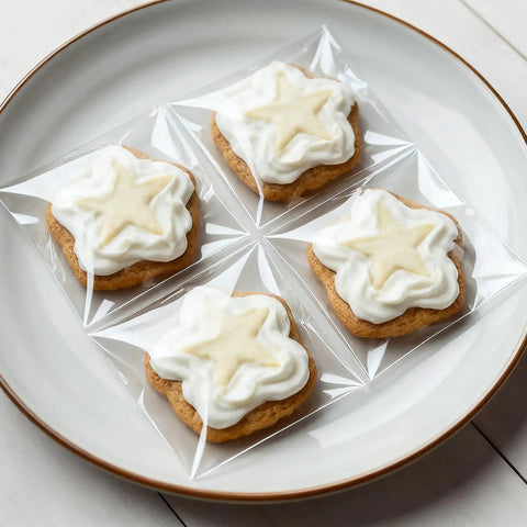 Clear Self Sealing Cellophane Bags 4x6 Inches 200 Pcs Resealable Bags For Cookies Candy And Treats Packaging Transparent Bakery Grade Bags With Easy Tear Grips For Quick Pack, displaying four cookies on a plate.