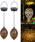 2 Pack Hanging Solar Lights With Moroccan Olive Pattern Lanterns illuminating a garden with metal outdoor waterproof design