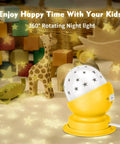 Rotating Star Projector Night Light For Nursery, yellow base, starry projection, with toys in background