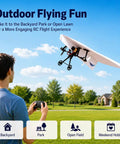 Person flying RC plane with DIY Electric Flight Kit featuring gyro stabilizer in outdoor park setting.