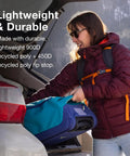 Woman loading collapsible wheeled carry on duffel into car trunk