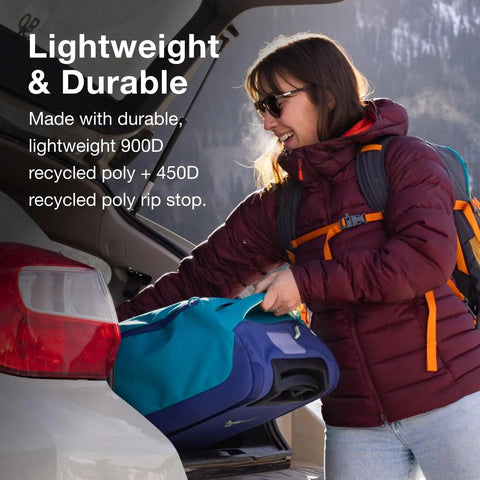 Woman loading collapsible wheeled carry on duffel into car trunk