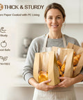 Woman holding 100 pack bread bags with clear window and 120 stickers for homemade bread storage sourdough bread bags