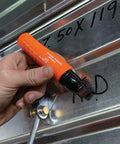 Hand using XL Chisel Tip Permanent Marker For Multi Surface Jobsite Use Black Ink That Writes On Wet Oily and Dry Surfaces