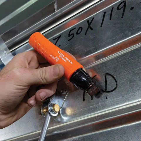 Hand using XL Chisel Tip Permanent Marker For Multi Surface Jobsite Use Black Ink That Writes On Wet Oily and Dry Surfaces