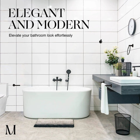 Modern bathroom with white tiles and a freestanding tub, showcasing contemporary fixtures and decor.