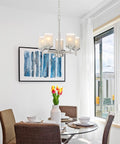 Dining room with Modern Farmhouse 19 Inch 5 Light Chandelier in Brushed Nickel Finish, frosted linen glass shades above table.