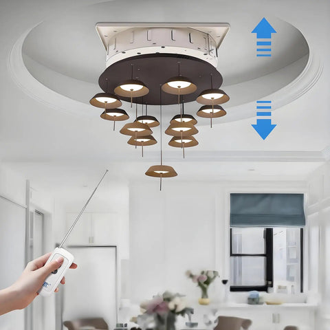 Top Tier Electric Chandelier Hoist With Remote Control Heavy Duty Lifting System Holds 330 Pounds lowering a modern lamp.
