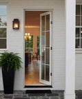 Front view of installed Black 4 Inch Self Closing Door Hinges on a white door, 5/8 inch radius corners, residential use