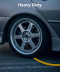 Grip And Go Hybrid Air Hose 3/8 Inch X 25 Feet With Quick Connect Fittings on the ground beside a car tire.