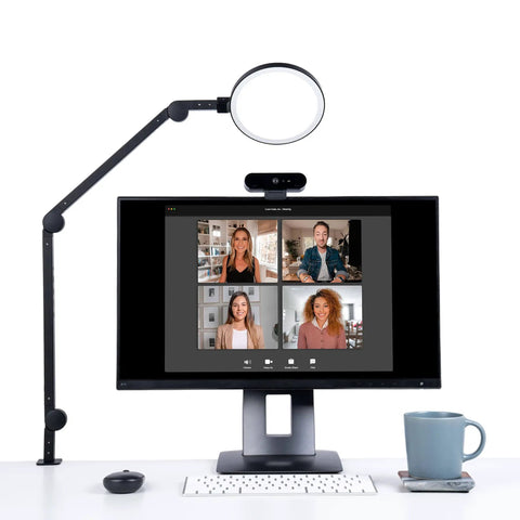 LED Desk Lamp For Home Office With Dimmable Brightness And Adjustable Color Temperature USB Charging Port Swing Arm Circle Webcam Light Touch Control And Boss Level Lighting For Video Calls next to monitor with video call on screen