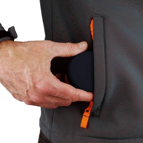 Person placing hard protective earphone case for earbuds and headphones in jacket pocket, showcasing compact size.